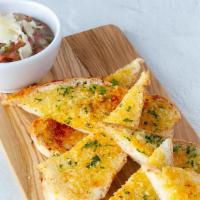 Bruschetta · Garlic cheese bread served with marinated plum tomatoes, onions, garlic and fresh basil.