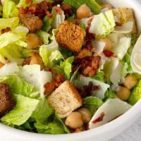 Hri Caesar · Romaine blend with caesar dressing, garbanzo beans, bacon, Parmesan cheese, and croutons.