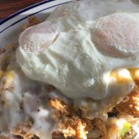 Cowboy Skillet · Two eggs (Any style) with home fries topped with Cheddar and Jack cheese, strips of chicken ...