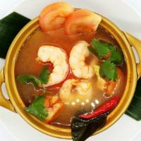 Tom Yum Koong · Shrimp in a tart lime juice, broth, fresh mushrooms, lemon grass, kaffir lime leaves, and Th...