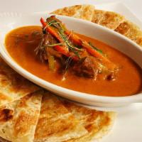 Beef Panang With Roti · Marinated beef simmered in a fragrant coconut curry sauce made with house spicy Panang curry...