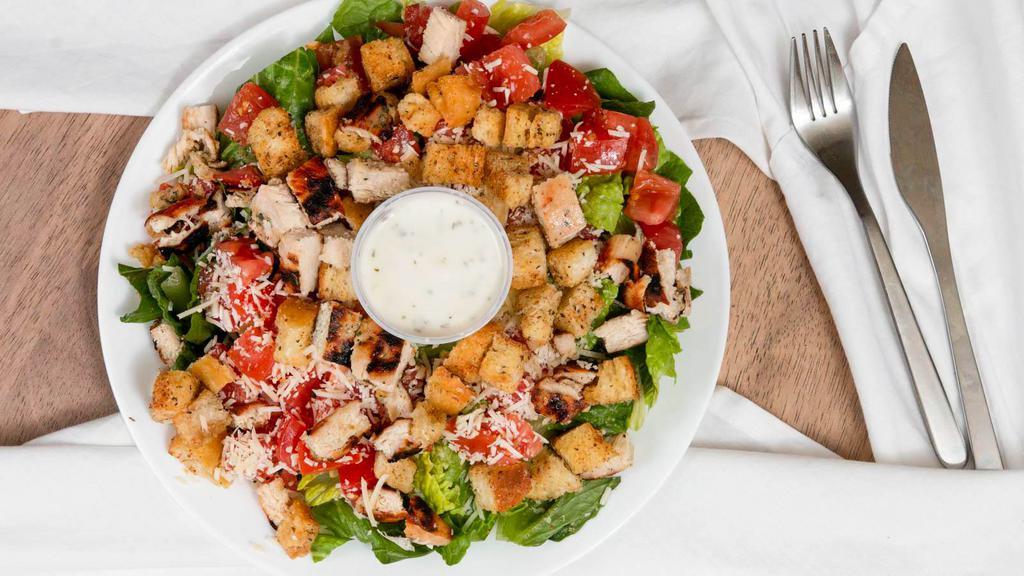 Grilled Chicken Caesar · Char-grilled chicken on a crisp bed of lettuce with tomato, croutons, caesar dressing, and Parmesan cheese.