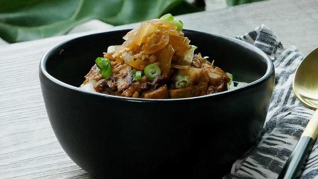 Pork Belly Rice · Chopped seared pork belly on steamed rice with a sweet onion drizzle.