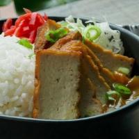 Japanese Curry W/ Tofu · Delicious mild Japanese curry with potatoes and carrots, on top of steamed rice. Served with...