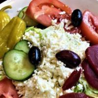 Greek Salad · Our Greek salad is specially prepared with chopped fresh lettuce, tomatoes, cucumber slices,...