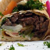 Beef Shawarma Wrap · Beef marinated and roll-broiled, with tomatoes, onions, parsley, pickle, and tahini sauce.