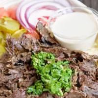 Beef Shawarma Bowl · Beef marinated and roll-broiled with baba rice, tomatoes, onions, parsley, and choice of hum...