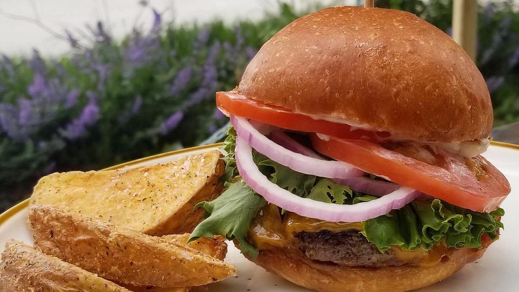 Classic Burger · 1/3lb local beef patty on an Amelia's bun with cheddar, mayo, lettuce, tomato and red onion. Stack a patty for $3.