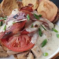 Hoosier Hot Brown · Herb roasted turkey over Texas toast with bacon and tomatoes, smothered in caramelized onion...