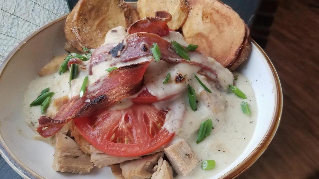 Hoosier Hot Brown · Herb roasted turkey over Texas toast with bacon and tomatoes, smothered in caramelized onion bechamel, with fried potatoes