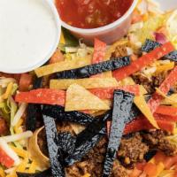 Crunchy Taco Salad · A large salad topped with taco meat, pico de gallo, cheddar cheese, fried corn tortilla chip...