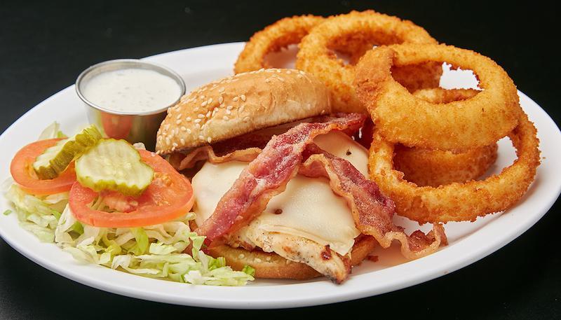 The Foul Shot Sandwich · Grilled chicken breast sandwich with melted Swiss cheese, crispy bacon, lettuce, tomatoes and house-made ranch dressing. Served with choice of side.