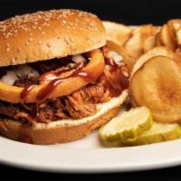 Pulled Pork Sandwich · Slow smoked, shredded pulled pork topped with BBQ sauce and an onion ring served on a sesame...