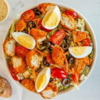 Crispy Chicken Salad · Crispy chicken, hard boiled egg, tomato, black olives, cheddar, and warm honey mustard dress...