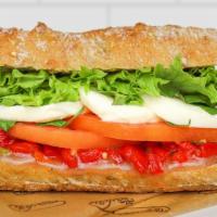 Caprese Sandwich · fresh mozzarella, vine-ripened plum tomato, roasted red peppers, basil + leafy greens on Fre...