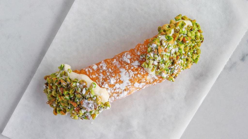 Cannoli · Sweet, creamy Ricotta & chocolate chip filling, topped with nuts, in cannoli shell.
