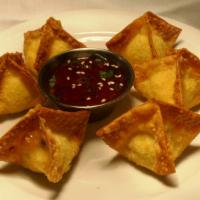 Crab Rangoons · Hand-made crab pouches served with a sweet chili dipping sauce.