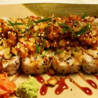 Spicy Scallop Roll · Crab, cucumber, avocado topped with spicy scallops, and eel sauce.