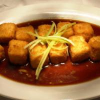 Crispy Tofu · Panko breaded, quick-fried, scallions, and tossed in a garlic sauce.  (Sauce is served on th...
