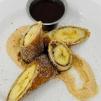 Banana Spring Roll · Two fried to order egg roll wrappers filled with banana and peanut butter, rolled in cinnamo...