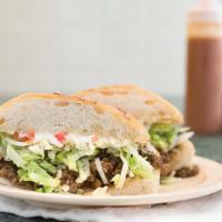 Steak Torta · Includes beans, cheese, lettuce, tomato, and sour cream.