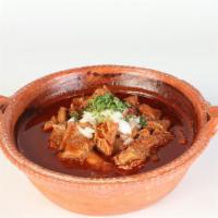Menudo · Traditional Mexican soup made with beef stomach in broth with red chili pepper base, topped ...