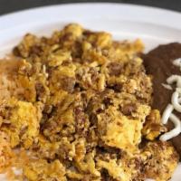 Huevos Con Chorizo · Scrambled eggs with chorizo with a kick of our traditional salsa, rice, and beans.