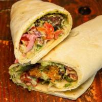 Spicy Falafel · Spicy red chickpeas fritters, pomegranate tomato coleslaw, green tahini  sauce, on flatbread