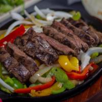 Steak Fajitas · Sizzling platter of caramelized onions and bell peppers with sliced marinated grilled skirt ...