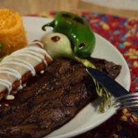 Tampiqueña · Charbroiled 9 oz. skirt steak served with a red cheese enchilada.