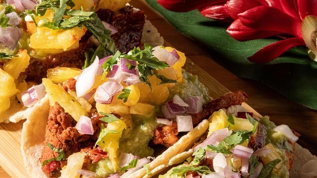 Al Pastor Tacos · Spit roasted pork, avocado salsa, morita salsa, pickled pineapple, cilantro, onion