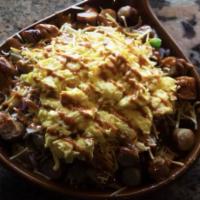 Huevos · Cubed potatoes, bacon, green peppers, red onions, sliced mushrooms, and Cheddar Jack cheese ...