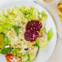 Greek Salad · Crisp iceberg and romaine lettuce, tomatoes, chickpeas, Feta cheese, pepperoncinis, kalamata...