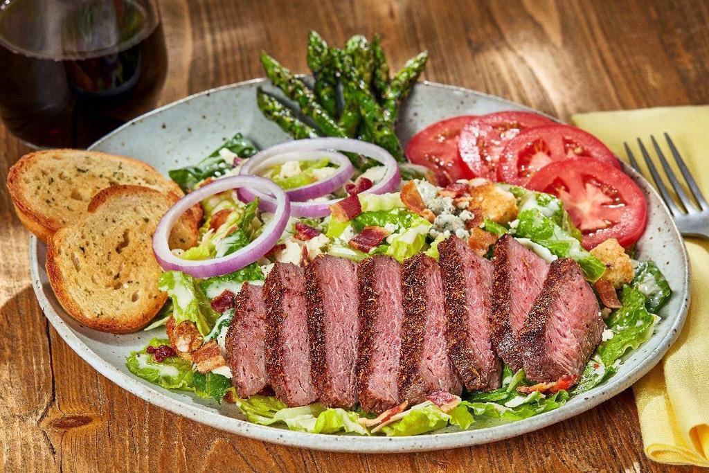Black, Bleu And Bacon Salad · Grilled asparagus, crisp Romaine lettuce tossed in Caesar dressing, topped with blackened USDA Choice sirloin,. tomatoes, onions, bacon, bleu cheese crumbles and toast points.