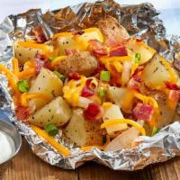 Campfire Potatoes (Premium Side) · Roasted potatoes topped with garlic butter, cheese, bacon and green onions wrapped in foil. ...
