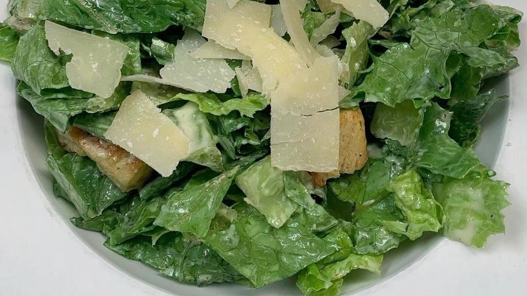 Side Caesar Salad · Caesar dressing, romaine, croutons, and Parmesan cheese.