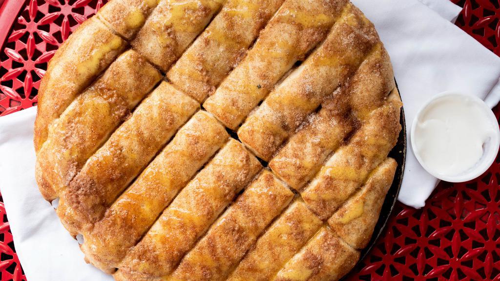 Cinnamon Bread · 16 piece sweet breadstick covered in butter and cinnamon sugar. includes 1 side of icing.