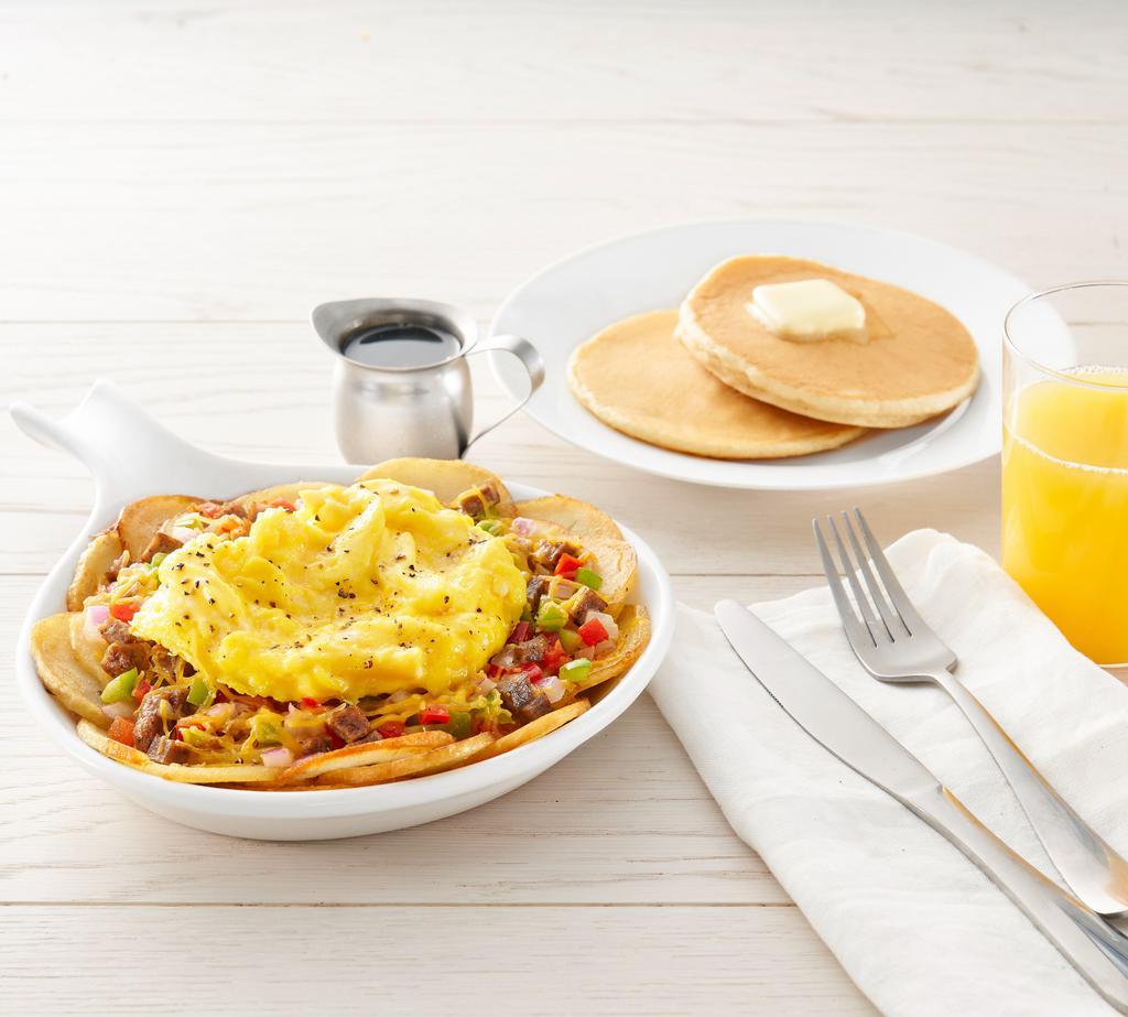 Country Harvest Skillet* · Eggs, sausage, onions, bell peppers and cheddar cheese all on top of homestyle potatoes. Choice of toast or pancakes (1690-1980 cal.)