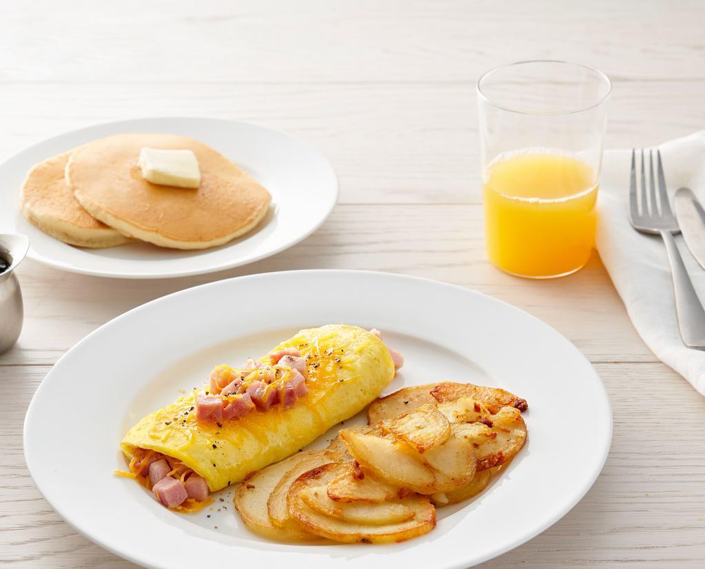 Ham & Cheese Omelet* · Three eggs, diced ham and cheddar cheese. Choice of side and choice of toast or pancakes (860-1460 cal.)