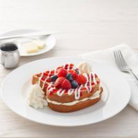 Berry Bliss Stuffed French Toast · Brioche French toast stuffed with mascarpone, and topped with strawberries, blueberries, ras...