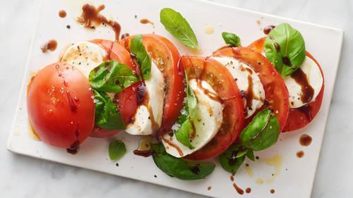 Caprese · Fresh mozzarella cheese, sliced roma tomatoes, extra virgin olive oil and basil, drizzled with a sweet balsamic glaze.