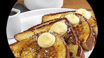 Classic French Toast · thick slices of texas toast battered in our signature french toast dip, served with syrup, m...