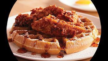 Chicken & Waffles · two hand-breaded chicken tenders served on top of a malted waffle with a side of butter, hot sauce, and syrup, make it a blockbuster! add 2 eggs, 2 bacon strips, and 2 sausage links for an additional charge.
