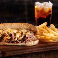 Philly Cheesesteak With Fries · seasoned shaved steak with mushroom and caramelized onion topped with four cheese sauce on a...
