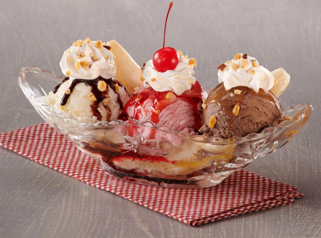 Big Boy Banana Split  · A whole banana piled high with scoops of big boy® chocolate strawberry and vanilla hand-dipped ice cream, then topped with strawberry, chocolate and caramel topping and garnished with whipped cream, crushed peanuts and a cherry.