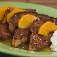 Southern Cobbler French Toast · Topped with peach cobbler compote then finished with cool whip and powdered sugar.