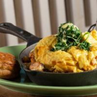 Martha'S Smoked Seafood Skillet · A bed of house potatoes, topped with eggs your way, tricolored peppers and onions, then stac...