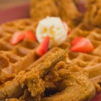 The Original Chicken & Waffle · Four fried wings with a belgian waffle garnished with butter and strawberries.