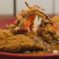 Knockout Catfish Acadian · Buttermilk marinated catfish seasoned then deep fried and served over buttered rice topped w...