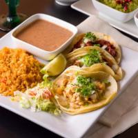 Taco Dinner · Three tacos choice of meat or vegetarian with rice and beans.